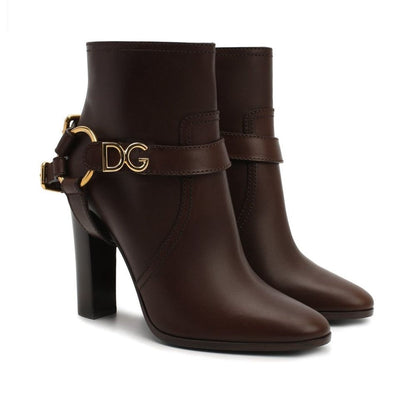 Dolce & Gabbana Brown Leather Ankle Boots with gold accent and round toe, featuring zip fastening and detachable name tag, made in Italy.