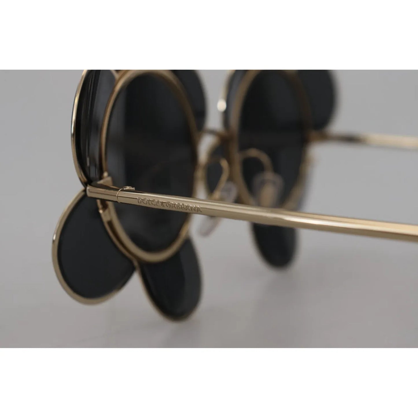 Side view of Dolce & Gabbana DG2201 Black Lens Gold Frame LIMITED EDITION Sunglasses with floral design detail.