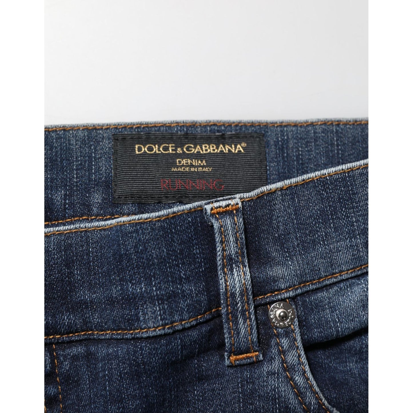 Dolce & Gabbana Dark Blue Washed Running Ripped Denim Jeans label close-up with classic five-pocket styling for modern streetwear.