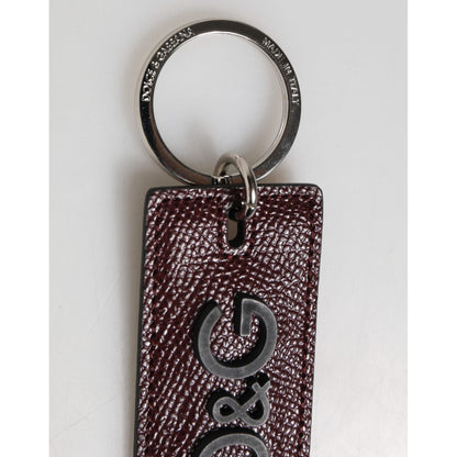 Dolce & Gabbana Dark Brown Leather Logo Metal Ring Men Keychain Keyring with silver detailing and engraved logo on calf leather.