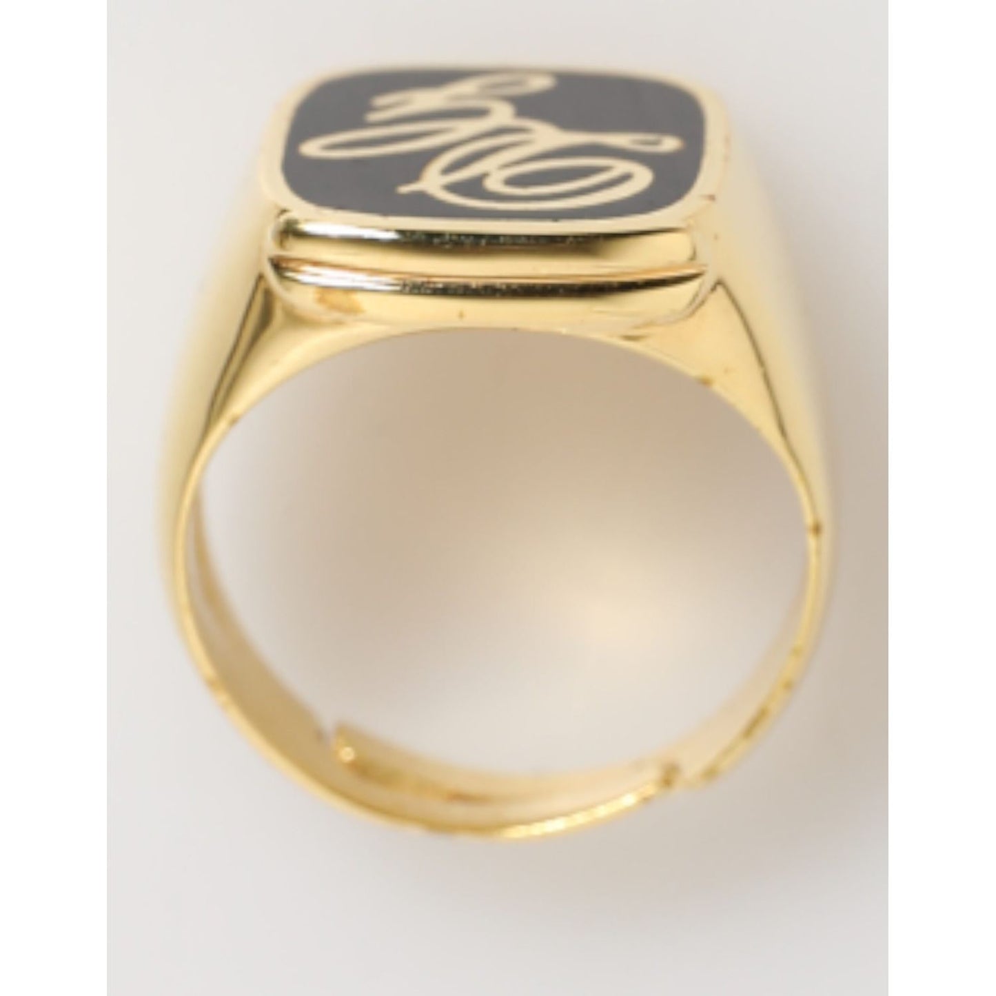 Dolce & Gabbana Gold Tone Enamel Brass Signet DG Logo Adjustable Ring with black enamel face and engraved logo.