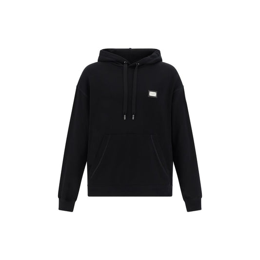 Dolce & Gabbana Hoodie in black cotton with adjustable hood, ribbed cuffs, D&G metal plaque, and kangaroo pocket. Oversized fit, AW25.