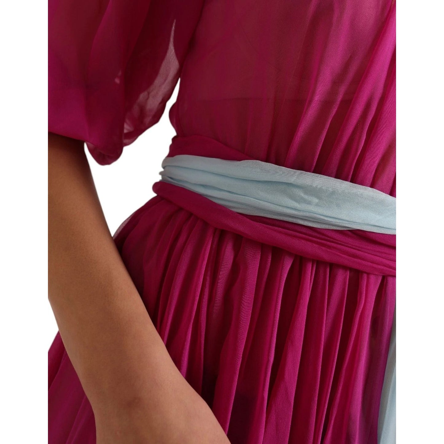 Close-up of Dolce & Gabbana Light Blue Silk Two Tone Midi Dress showcasing fuchsia fabric and light blue waistband with logo details.