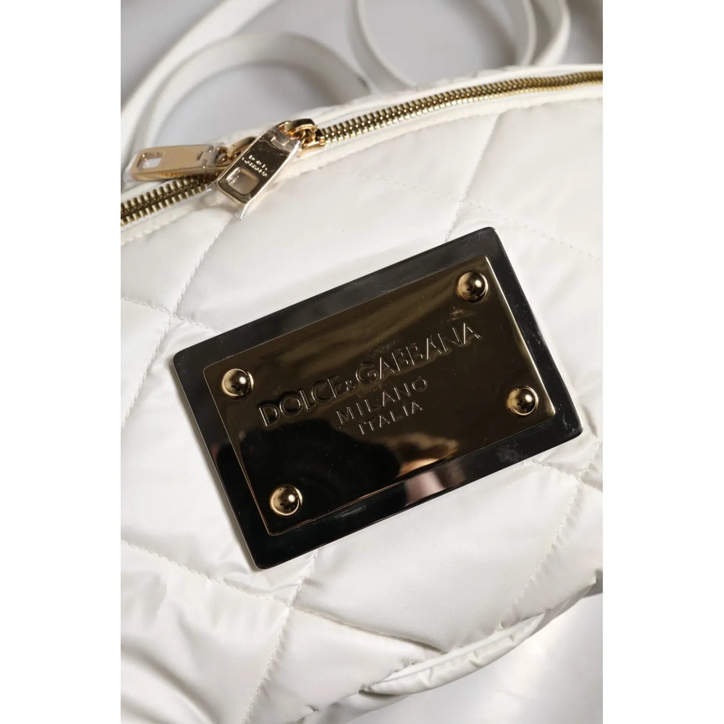 Close-up of gold-tone logo plaque on Dolce & Gabbana White Quilted Logo 90's Sicily Belt Waist Fanny Pack Bag.