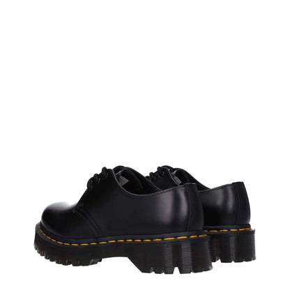 Dr. Martens Black Leather Oxfords And Derbies, lace-up casual shoes with rubber sole, mid heels, round toe design.