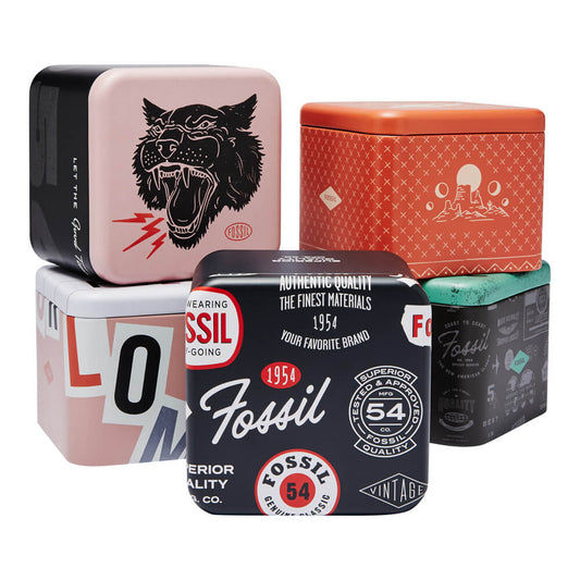Stack of colorful Fossil watch boxes showcasing unique designs and patterns.