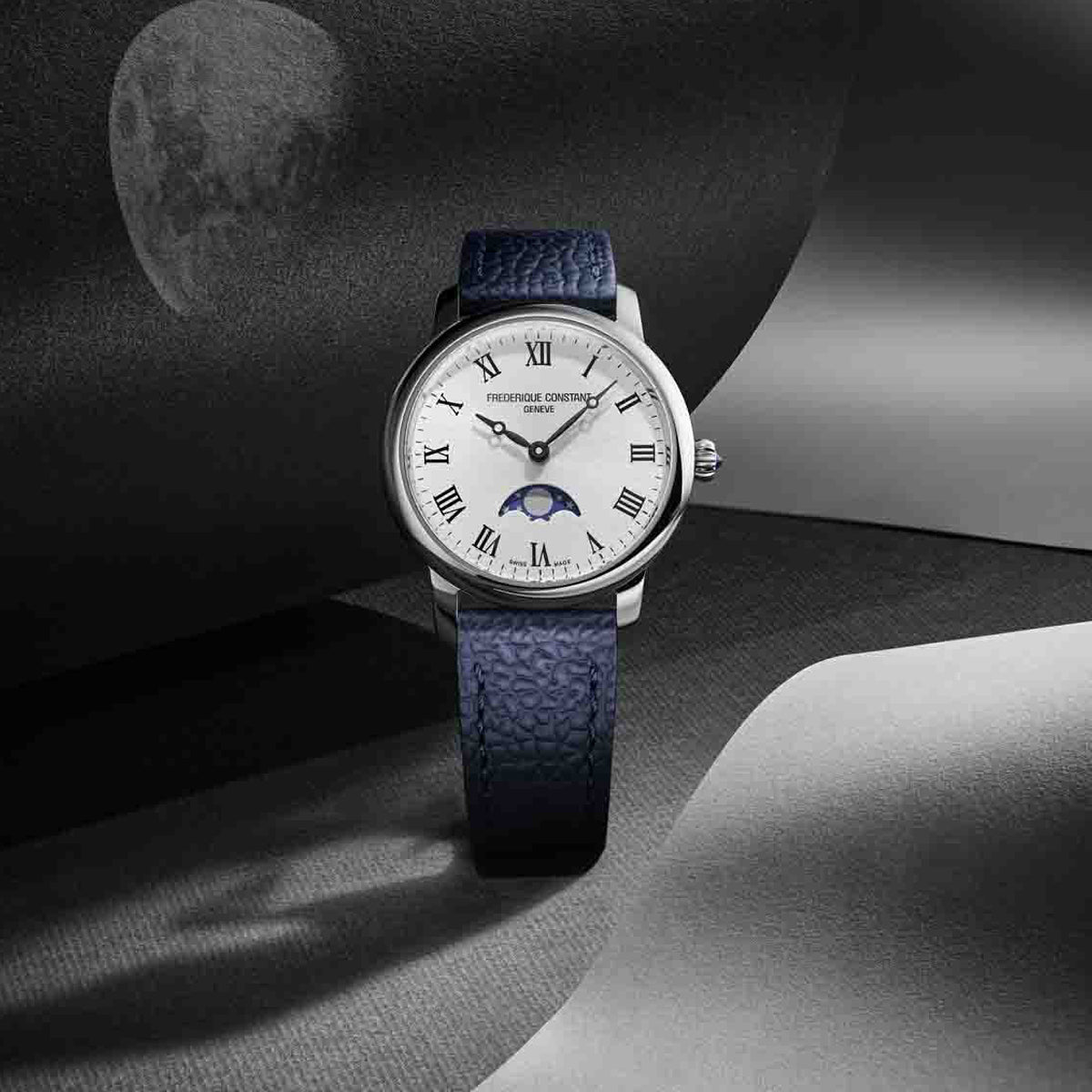 FREDERIQUE CONSTANT MOD. FC-206RS1S6 luxury watch with blue leather strap and Roman numeral dial on artistic background.