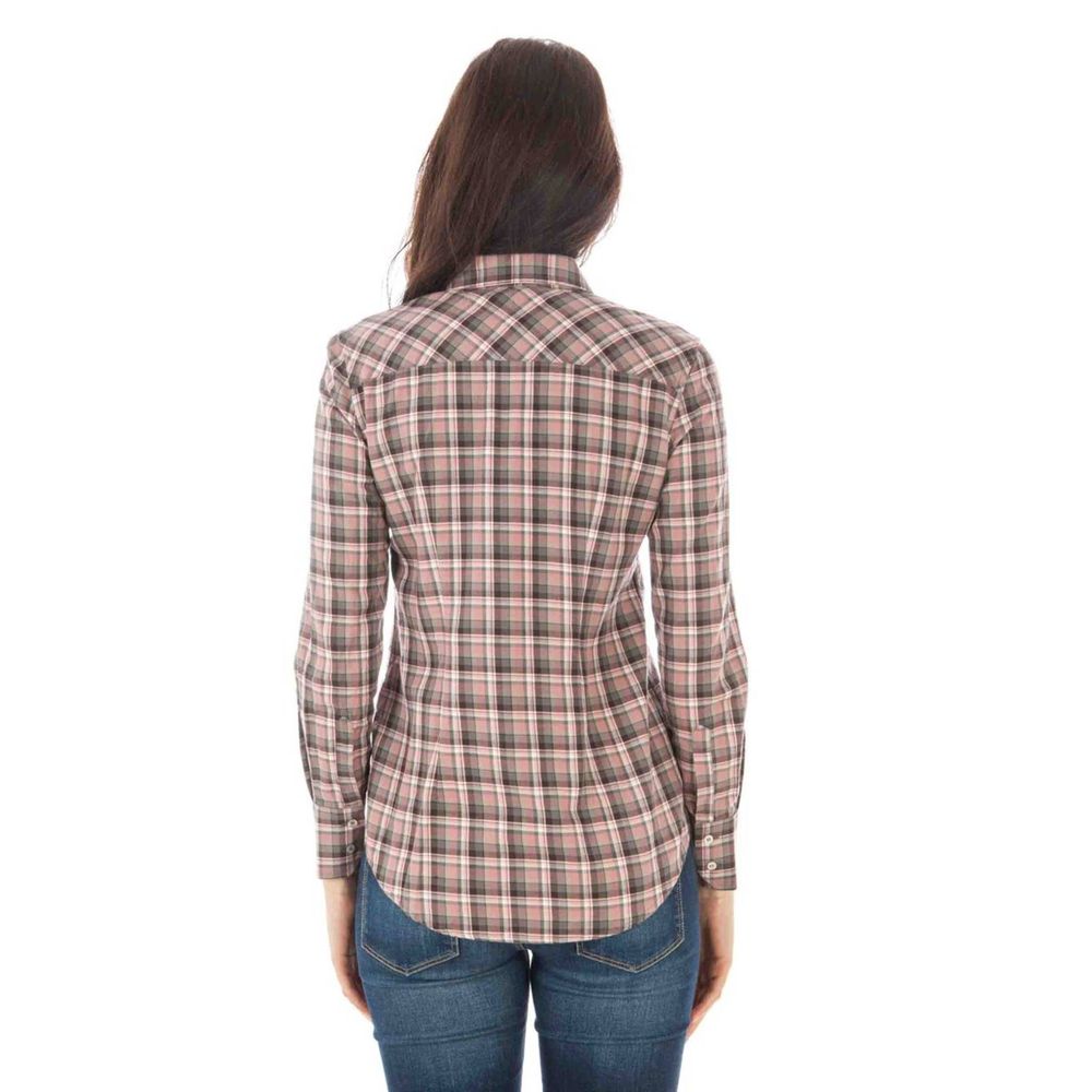 Back view of woman wearing a plaid long-sleeved shirt and jeans on a white background.