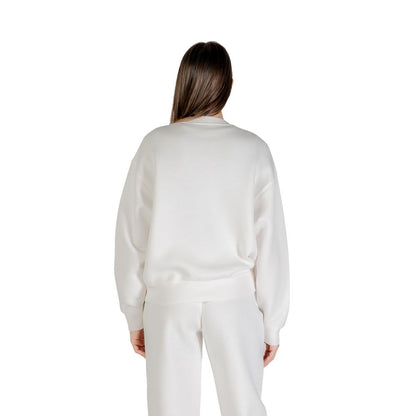 Back view of woman wearing Guess Active Cream Viscose Sweatshirt showcasing elegant design and soft fit.