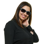 Woman wearing HARLEY-DAVIDSON MOD. HD0300X 5684A sunglasses, smiling with UV protection, official packaging for ladies.
