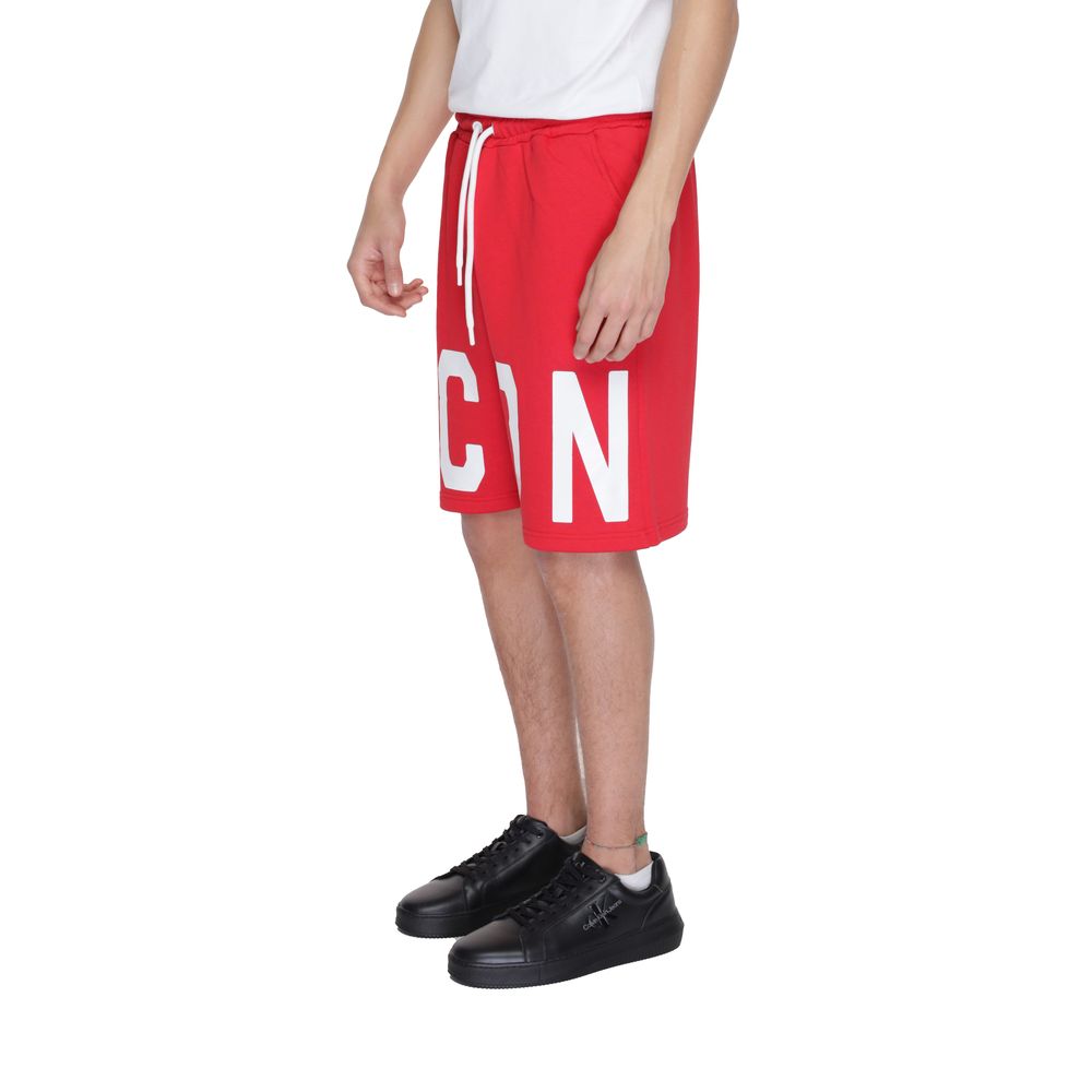 Model wearing Icon Red Cotton Bermuda Shorts with 'ICON' print, drawstring waist, and side pockets for urban style and comfort.