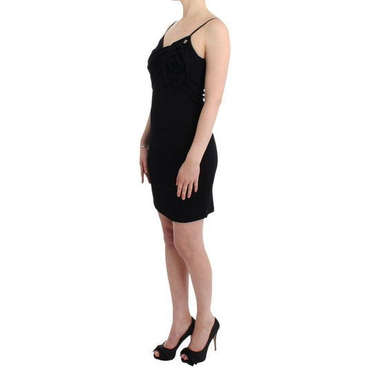 Woman wearing John Galliano Black coctail dress, above knee length, with spaghetti straps and logo, showcasing a chic evening look.