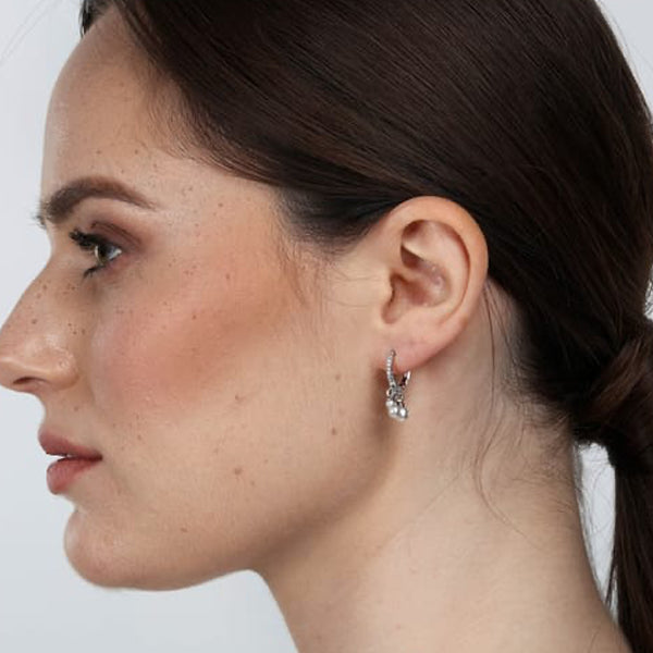 LA PETITE STORY JEWELRY Mod. LPS02AQM25 earring shown on woman's ear, showcasing elegant design and fine craftsmanship.