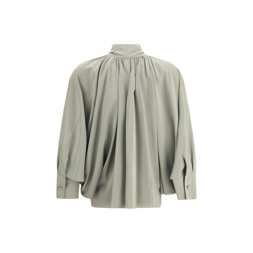 Back view of Max Mara Green Silk Blouse with flowing fit, batwing sleeves, and asymmetrical hem, featuring high cuffs and metal jewel loop detail.