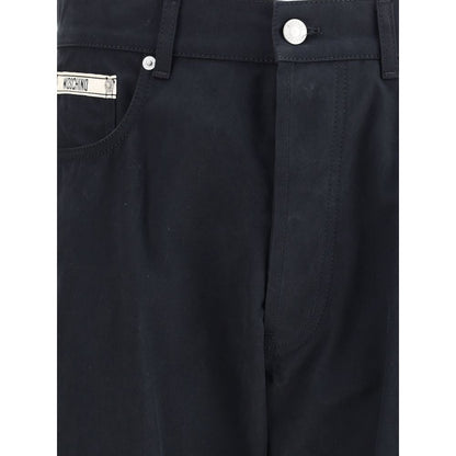 Close-up of Moschino Black Cotton Casual Pants showcasing front patch and zip-button closure.