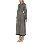 Woman wearing Only Black Recycled Polyester Long fall/winter dress, composed of 68% recycled polyester and 32% polyester, standing sideways.