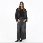Model wearing PINKO Black Cotton Skirt with zip closure, showcasing long design, back and side flap pockets for stylish look.