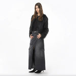 Model wearing PINKO Black Cotton Skirt with zip closure, and multiple pockets, styled with a black fur jacket and ankle boots.