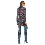 Back view of model wearing PINKO Black Polyester Suits & Blazer with floral pattern, holding blue purse and wearing blue knee-high boots.