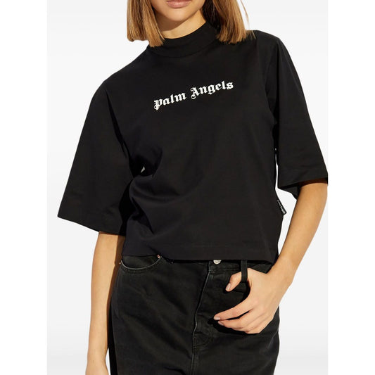 Palm Angels crop T-shirt with logo in black, crew neck, short sleeves, worn by model, highlighting fashion-forward street style.