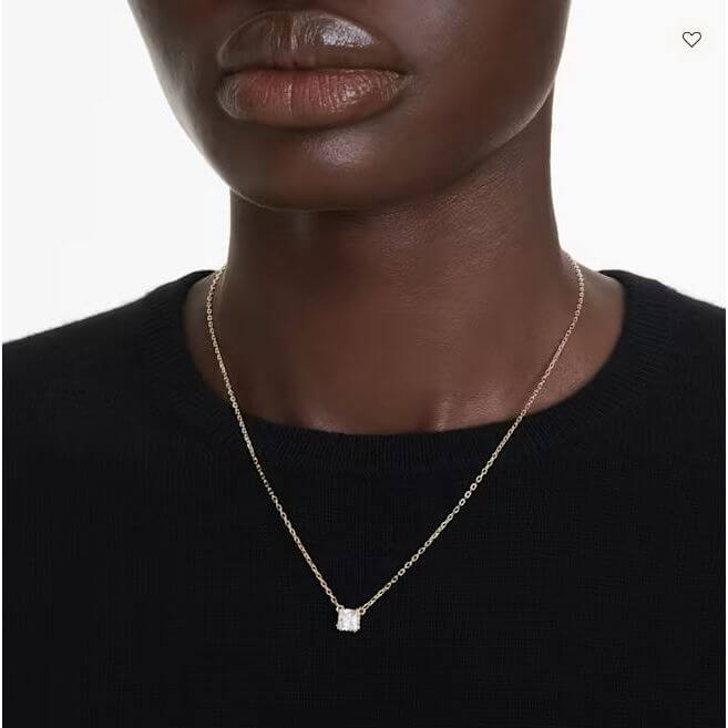 Elegant necklace displayed on a mannequin against a white background.