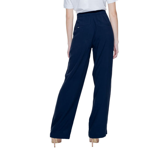 Back view of woman wearing Street One Blue Viscose Pant, showcasing tapered fit and double button fastening.