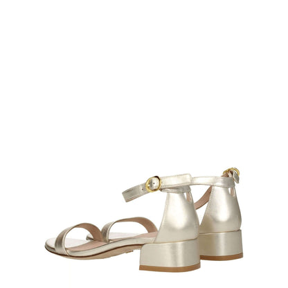 Stuart Weitzman Gold Leather Sandals with buckle closure and mid heels, open toe design, in metallic platinum leather, back view.