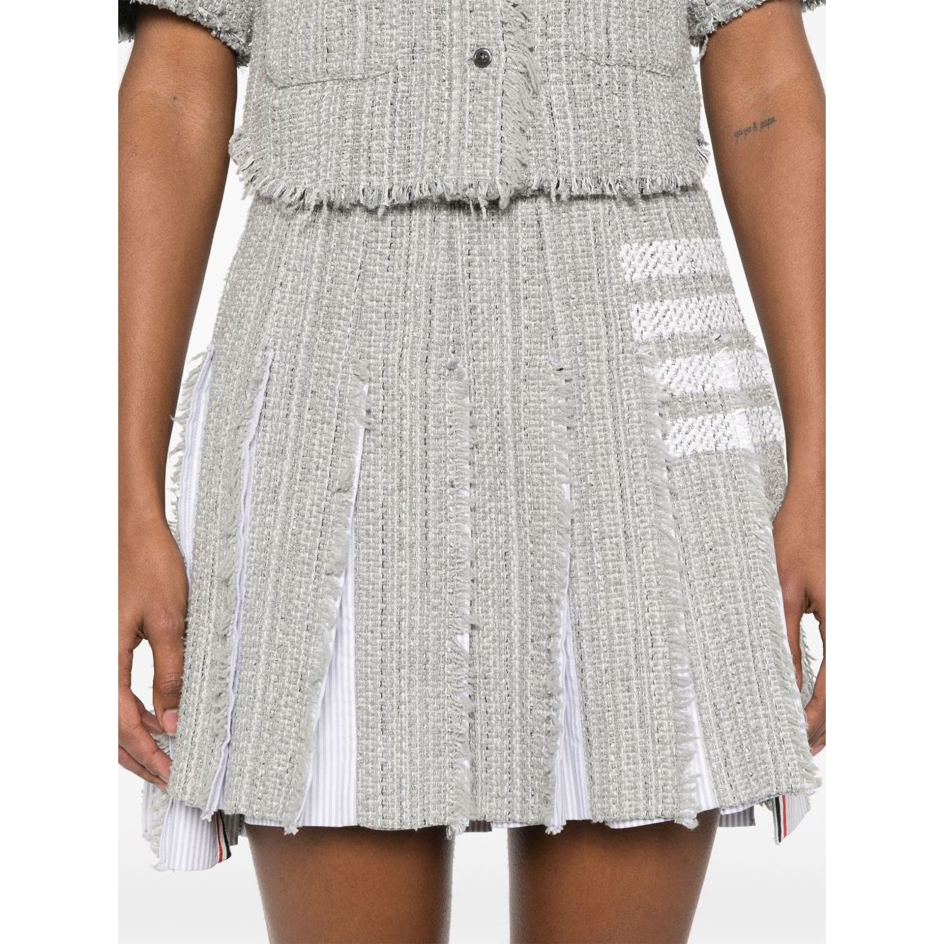 Medium grey cotton blend skirt featuring side button and zip fastening, frayed edges, and signature 4-Bar stripe by Thom Browne Skirts Grey.