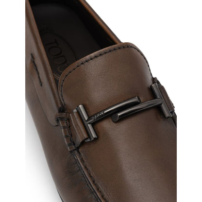 Tod's Brown Leather Moccassin with metal decoration and Gommino sole showcasing Italian craftsmanship.