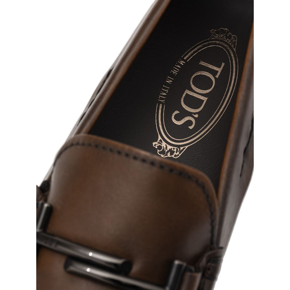Close-up of Tod's Brown Leather Moccassin with metal decoration and Gommino sole, showcasing Made in Italy craftsmanship.