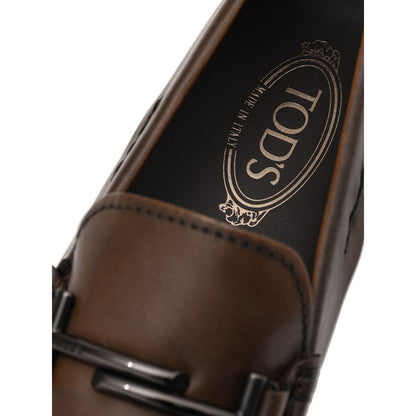 Close-up of Tod's Brown Leather Moccassin with metal decoration and Gommino sole, showcasing Made in Italy craftsmanship.