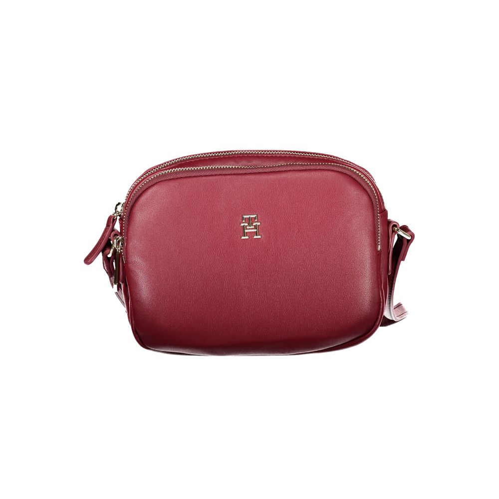 Tommy Hilfiger Red Polyester Handbag with adjustable shoulder strap, zip closure, and logo, featuring two compartments and one internal pocket.