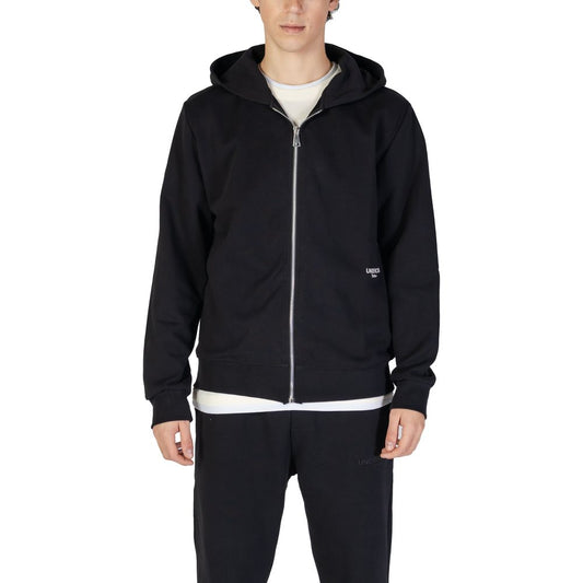 Model wearing Underclub Black Cotton Hoody with zipper, showcasing casual style, front view.
