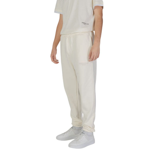 Model wearing Underclub Cream Cotton Joggers Workout Pant, showcasing comfort and style with elastic cuffs and drawstring waistband.