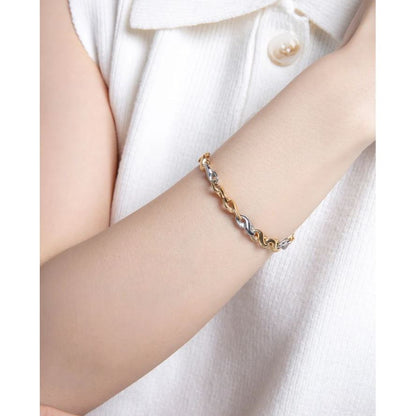 Woman wearing VICEROY FASHION Mod. 14176P01012 silver and gold bracelet, close-up view, elegant jewelry, quartz analog, 5 ATM water resistant.