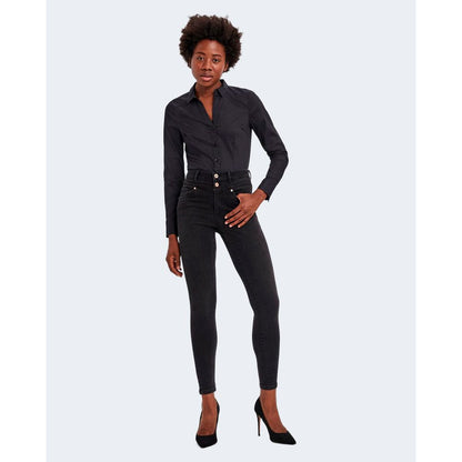 Model wearing Vero Moda Black Cotton Bodysuit paired with black jeans and heels, showcasing a versatile casual and elegant look.