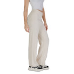 Woman wearing Vero Moda Cream Viscose Pant, wide-leg palazzo style, paired with a white top and sneakers, demonstrating fit and style.