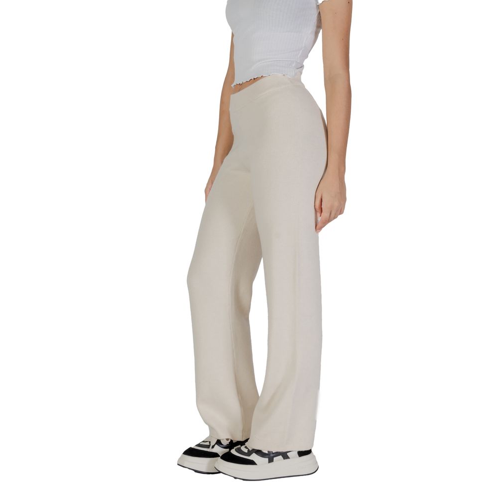 Woman wearing Vero Moda Cream Viscose Pant with wide-leg palazzo cut and casual sneakers.