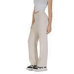 Woman wearing Vero Moda Cream Viscose Pant with wide-leg palazzo cut and casual sneakers.