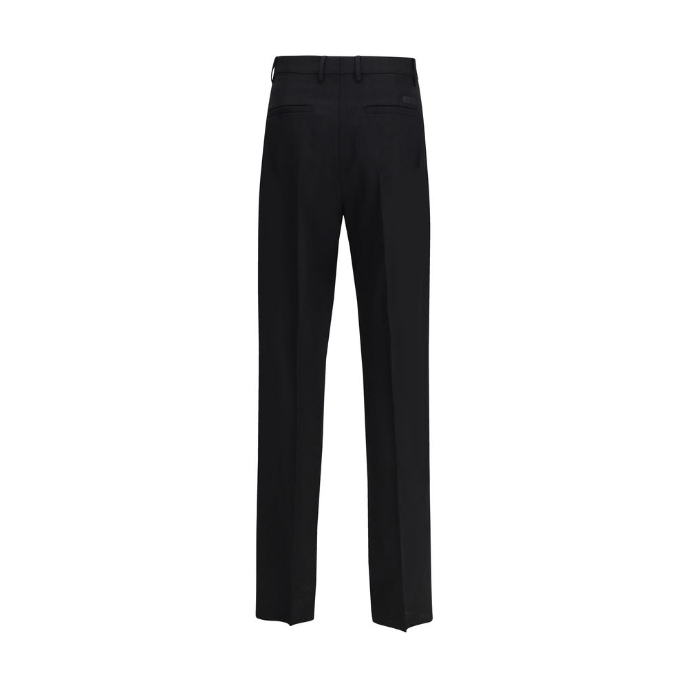 Back view of Versace Black Fleece Wool Dress Pants showcasing slim fit and tonal jacquard label.