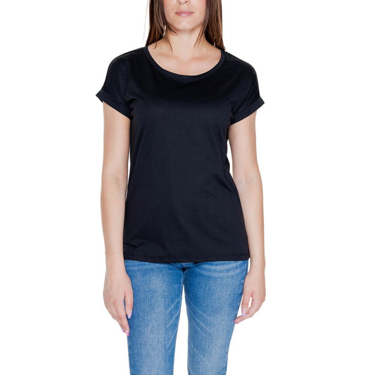 Woman wearing Vila Clothes Black Cotton T-Shirt with short rolled sleeves and round neckline, paired with blue jeans.