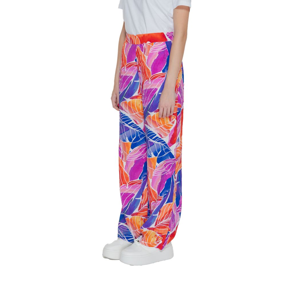 Woman wearing Vila Clothes Multicolor Viscose Pant with tropical leaf print, showcasing vibrant colors and a wide, flowing silhouette.